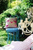 A cushion on a blue garden chair