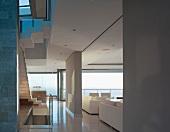 Open plan house with room dividers separating the staircase from the living room with a view of the sectional sofa