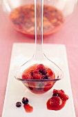 Berry punch on a ladle and in a glass bowl