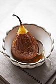 A baked pear with honey sauce