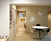 Dining room with chairs in Bauhaus style and view through an open hallway