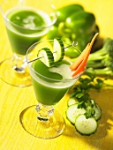 Green vegetable juice garnished with cucumber and carrots