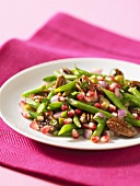Bean and pomegranate salad with pecan nuts
