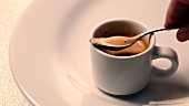 Espresso crema being stirred