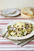 An apple, fennel, pomegranate seed and cheese salad