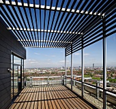 Modern roof terrace with pergola and panoramic view of city