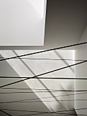 Cables stretching across an area under a white ceiling