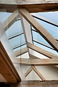 View of a modern skylight above old, rustic wooden construction