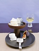 A cheese platter with goat's cheese and white wine