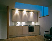 Custom made kitchen in designer style under a skylight