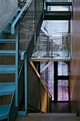 Narrow stairwell with metal stairs and banister