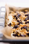 A chocolate crumble cake on a baking tray