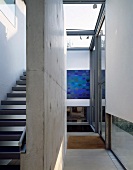Modern, open stairway with concrete dividing wall