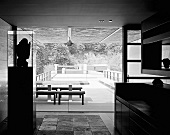 Japanese house with open sliding doors and a view of courtyard with a table and benches