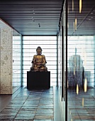 Buddha statue in a minimalist lobby on slate tiles