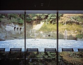 View through a glass facade of a traditional, Japanese courtyard