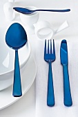 White crockery and blue cutlery