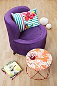 Purple lounge chair with velvet upholstery next to a Moroso table
