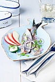 Dutch soused herring on a fish-shaped plate