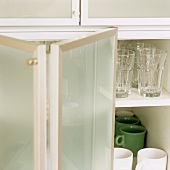 A kitchen cupboard with folding doors