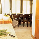 A view from a kitchen into a dining room