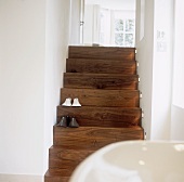 Two pairs of slippers on a wooden stair