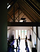 A yoga class in a renovated attic with wooden beams