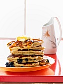 Pancakes with blueberries, butter and maple syrup