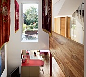 Gallery on landing with view down into open-plan kitchen, floor-to-ceiling window above