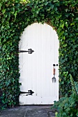 White door surrounded by ivy