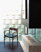 50s armchair in front of white structured wall