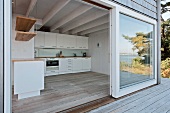 Open sliding terrace door with view of kitchen