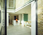 Glass extension with view into open-plan living room with kitchen area