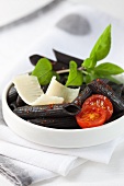 Black pasta salad with tomatoes and Parmesan cheese
