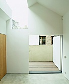 Bare bedroom with skylight and open terrace door