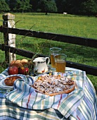 Apple tart on a table in the open air (Normandy, France)