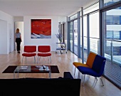 Espresso break in modern living room with coloured armchairs