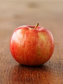 A red apple on a wooden surface