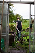 A woman digging a flower bed