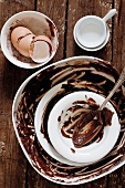 Bowls with the remains of a chocolate cake mixture and eggshells