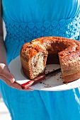 A woman holding a marble cake
