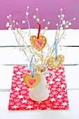 Heart-shaped Christmas biscuits hanging on a twig