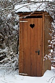 Wooden hut with dry toilet in garden