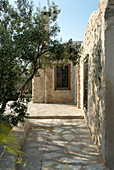 Stone house with olive tree in courtyard (Tunisia)