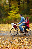 Young couple cycling to a picnic
