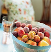A bowl of apples and plums