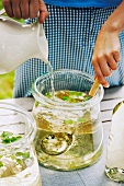Mineral water being added to punch