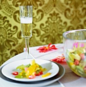 Plates of salad and glasses of champagne on a table