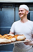 A baker with freshly baked bread