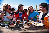 People having lunch outside a ski hut (France)